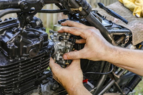 a-person-holding-a-car-engine.jpg a person holding a car engine